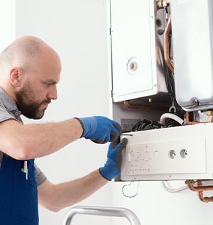 Technician repairing a water heater, demonstrating appliance repair expertise related to Carter Services' home services in Torrance, CA.
