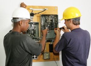 technicians fixing breaker panel
