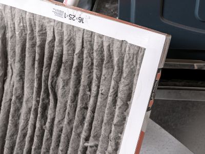 Air filter showing accumulated dust and debris, illustrating the importance of regular replacement for HVAC efficiency and improved indoor air quality.