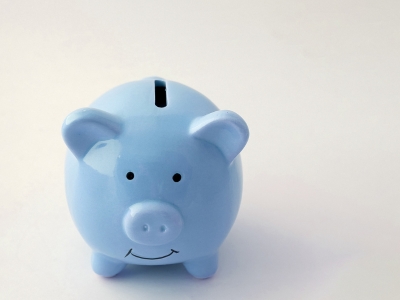 Blue piggy bank symbolizing savings and financial efficiency, relevant to plumbing maintenance cost savings.